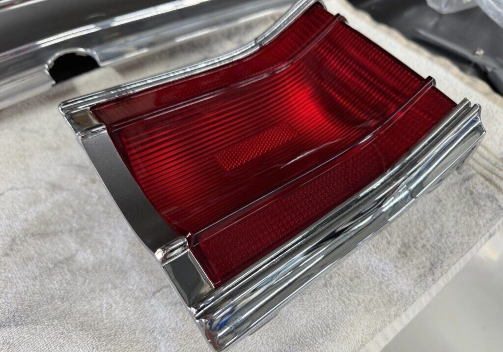 Red car taillight on a white surface.