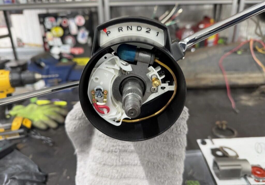 Car gear shift mechanism on workbench.