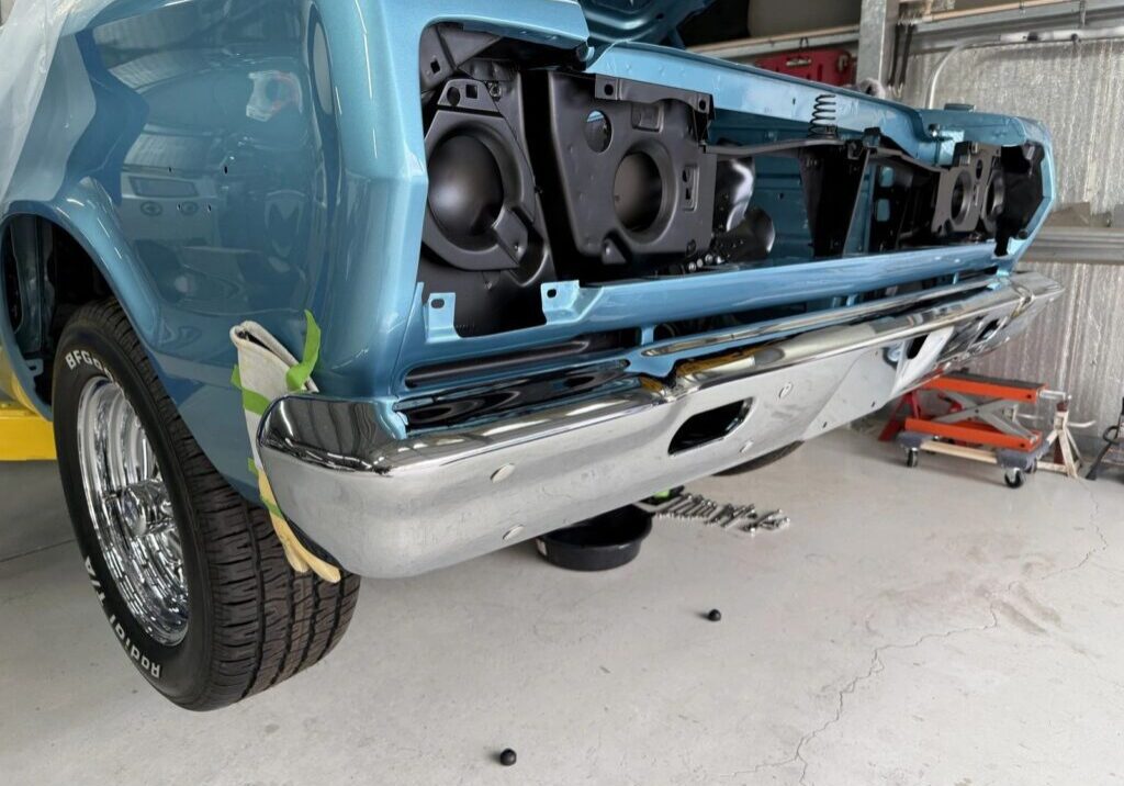 Classic car under restoration in garage.