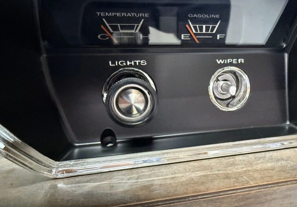 Dashboard controls with temperature and fuel gauges.