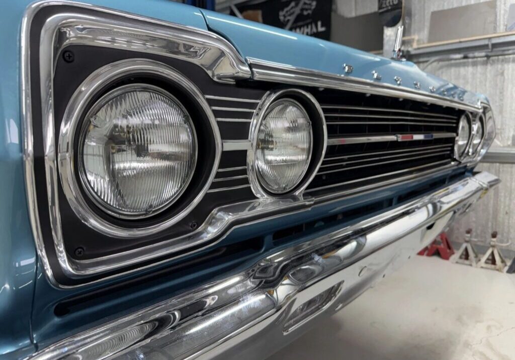 Classic blue car with chrome grille.